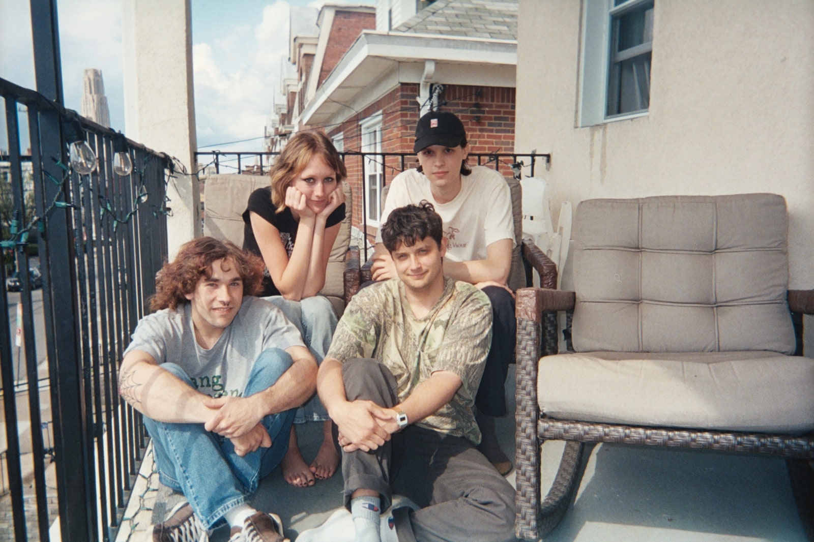 The band Feeble Little Horse posing together on a porch